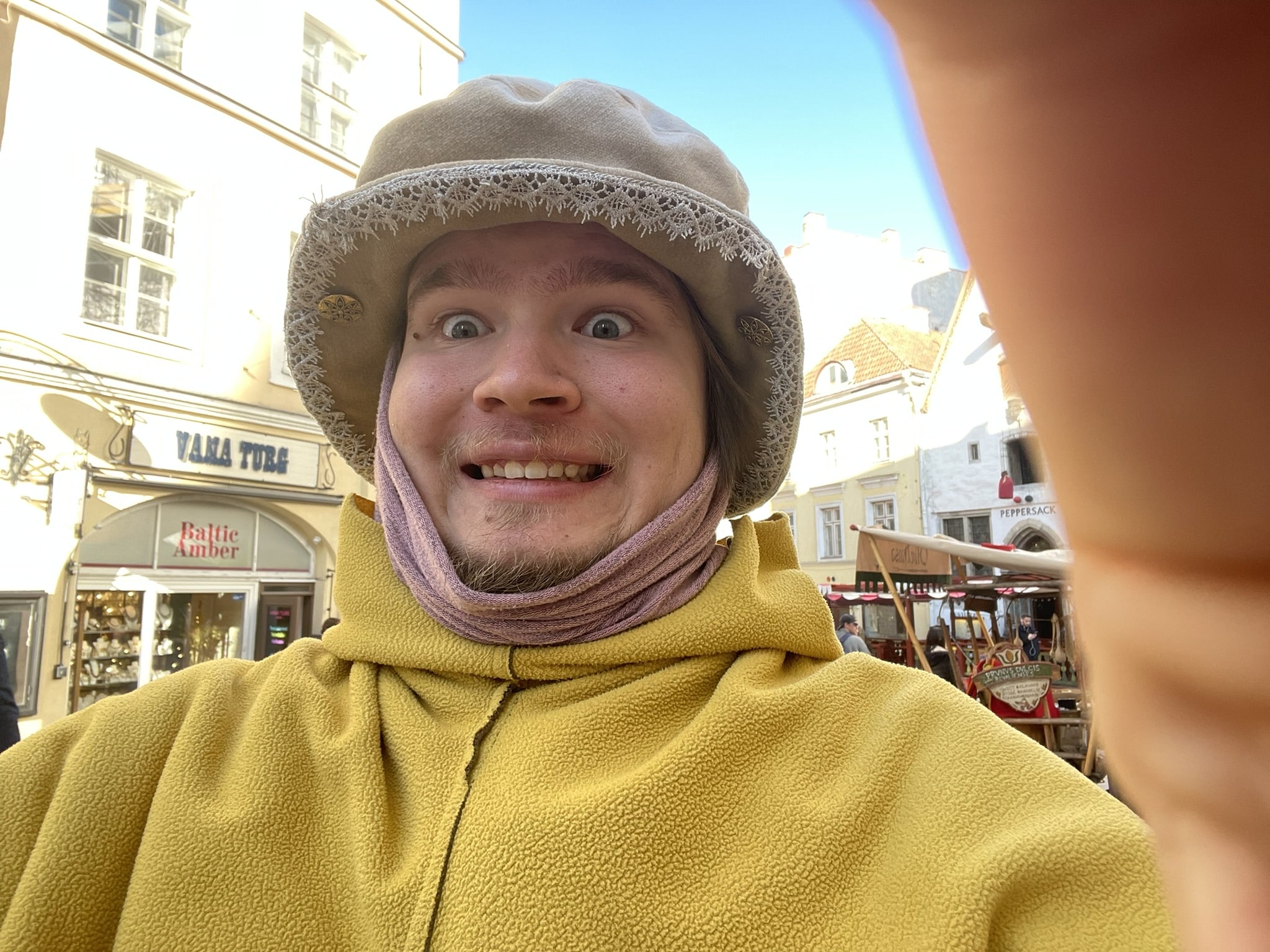 A grinning selfie style photo of a man in medieval garb