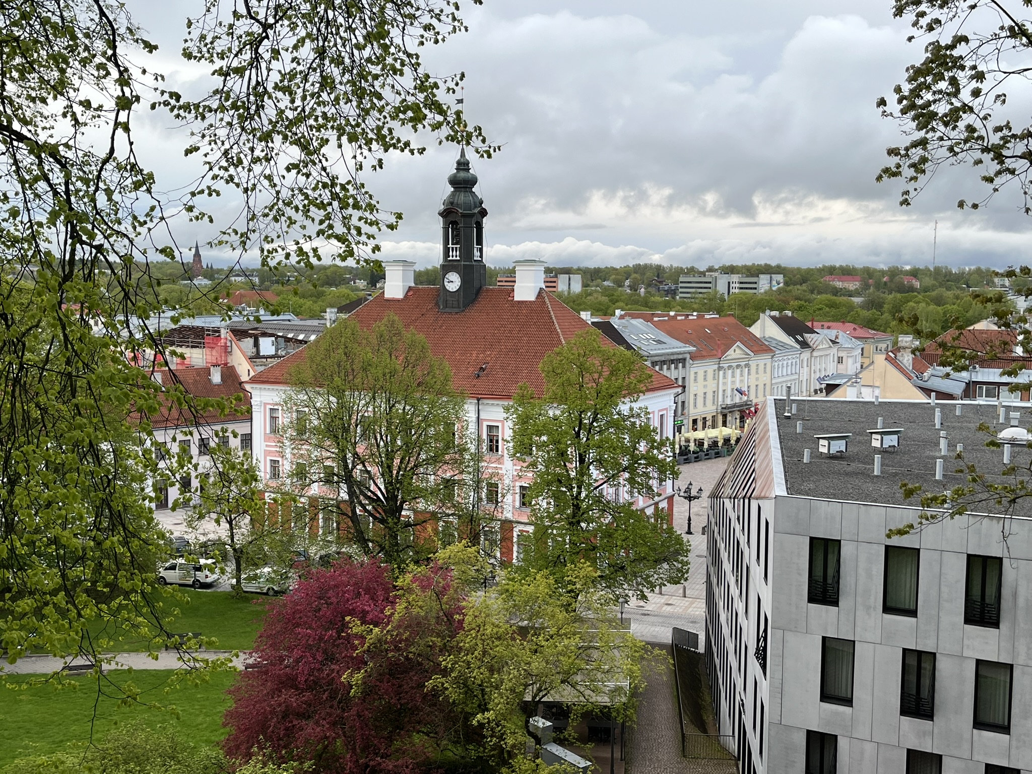 view from atop a hill, looking down on a baroque municipal building