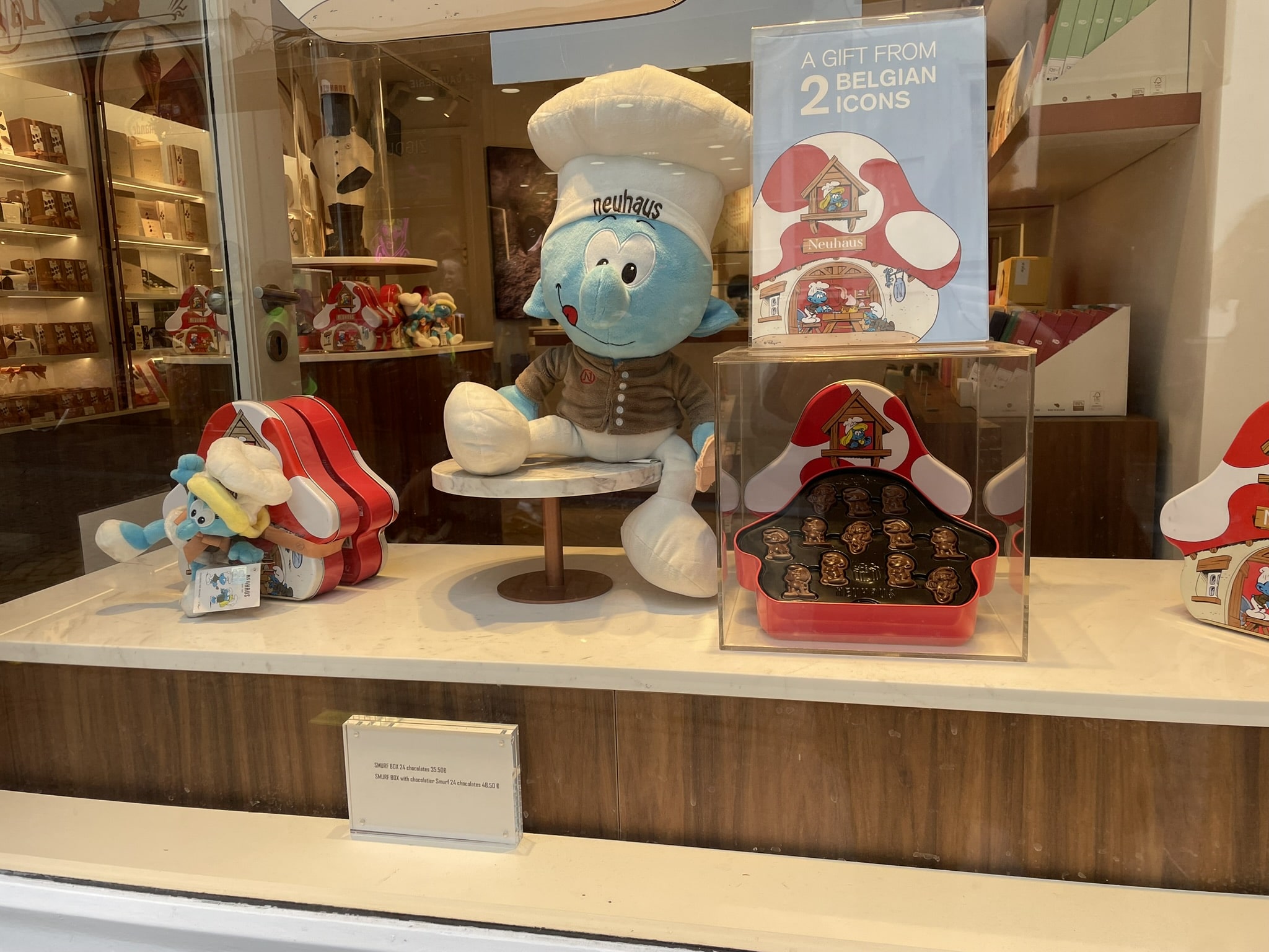 styffed smurf in a window display with chocolates