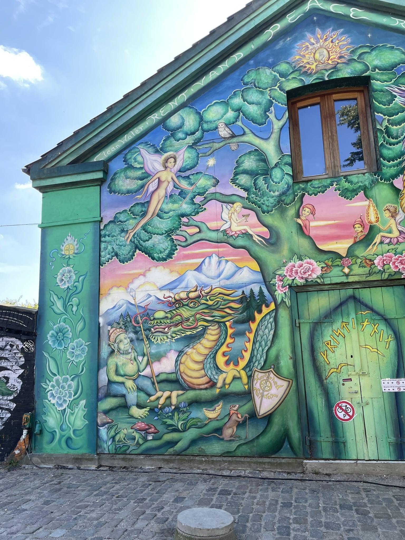 building painted with dragon, fairy, and troll