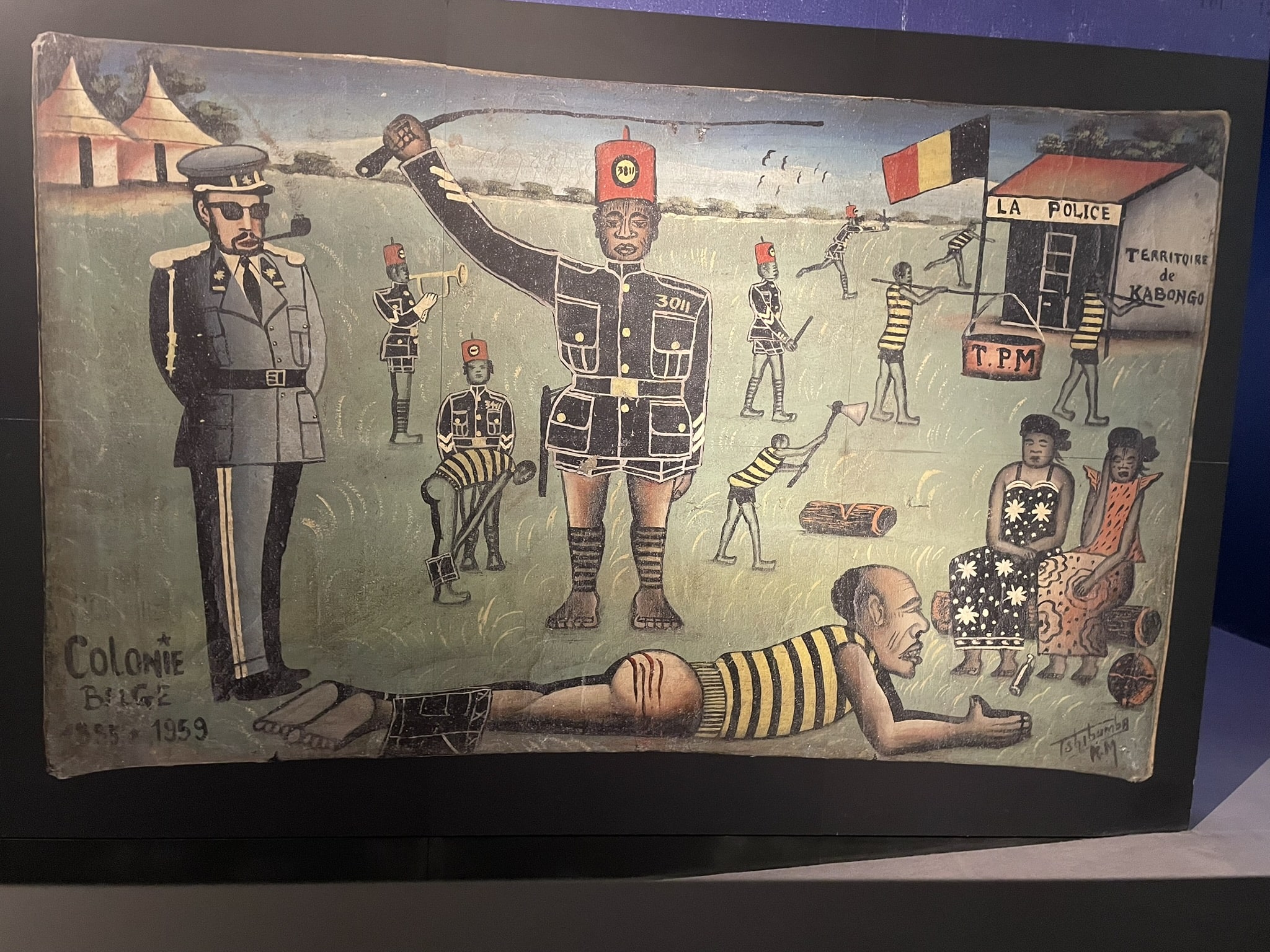 naive art depiction of a black man in uniform whipping a black man, while a white informed man smoking a pipe looks on