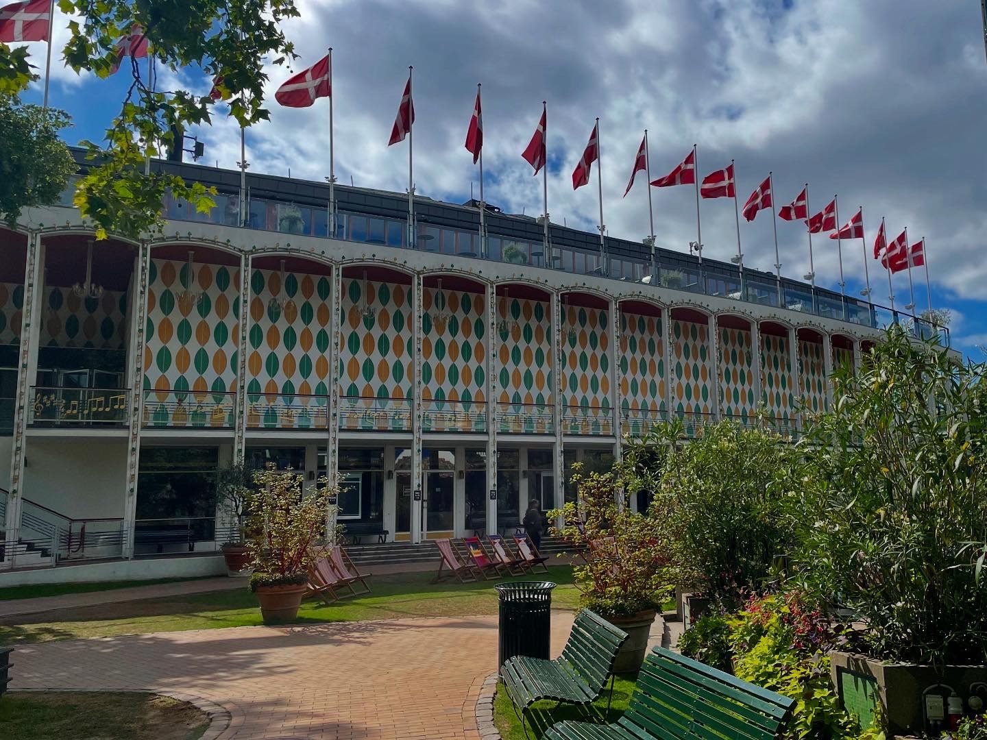 colorfully patterned building topped with many Danish flags