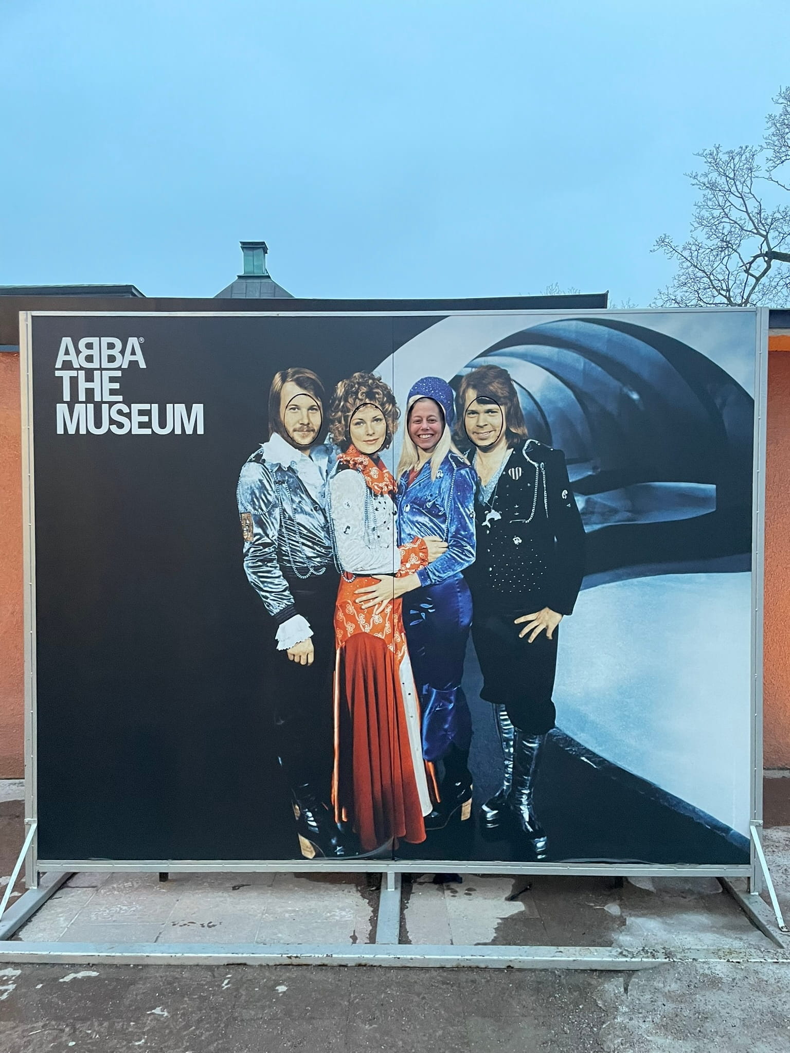 posterboard of the band ABBA, with faces cut out for people to take photos of their own face as a band member
