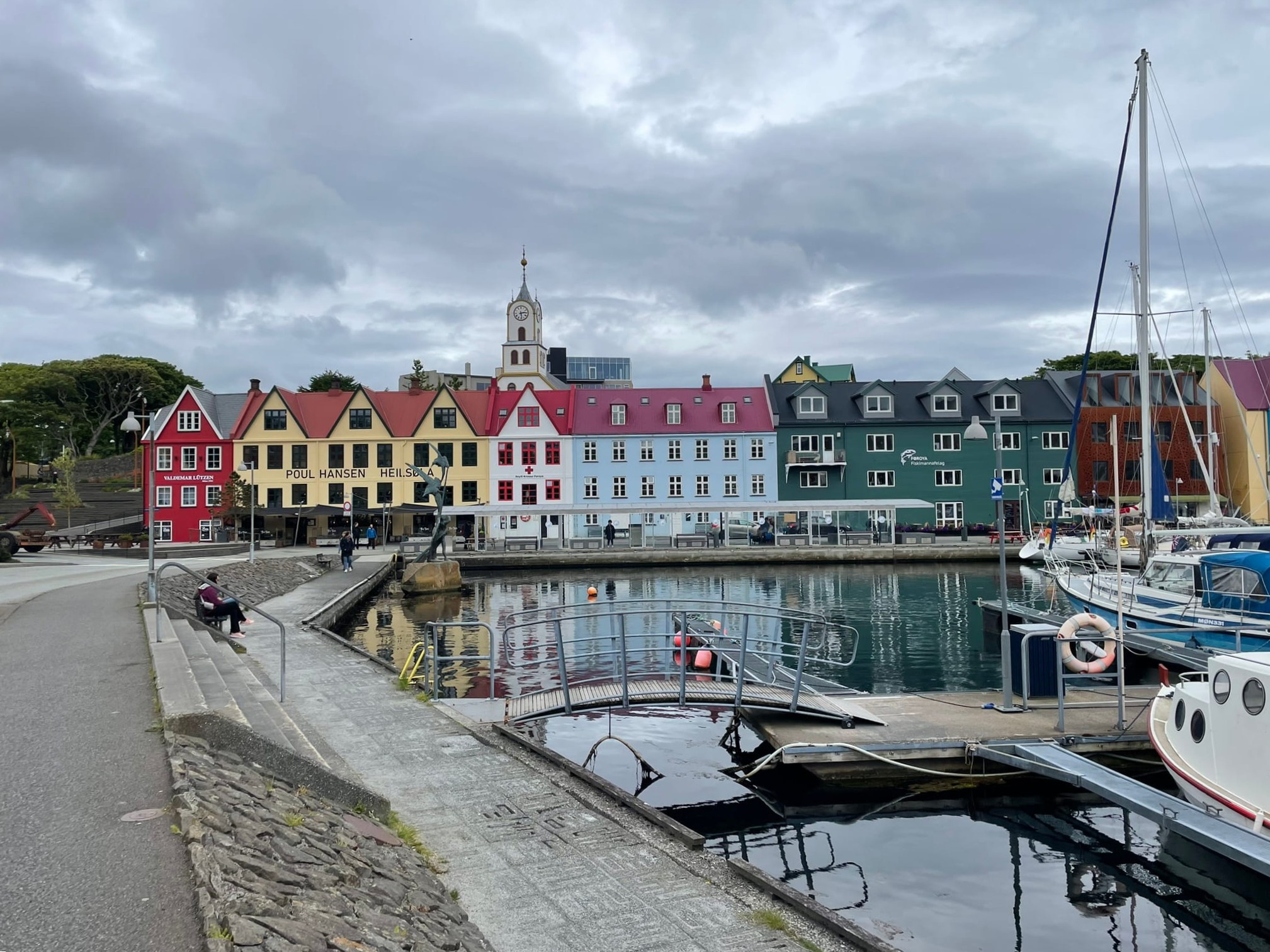 pastel colored buildings alongside a harbor