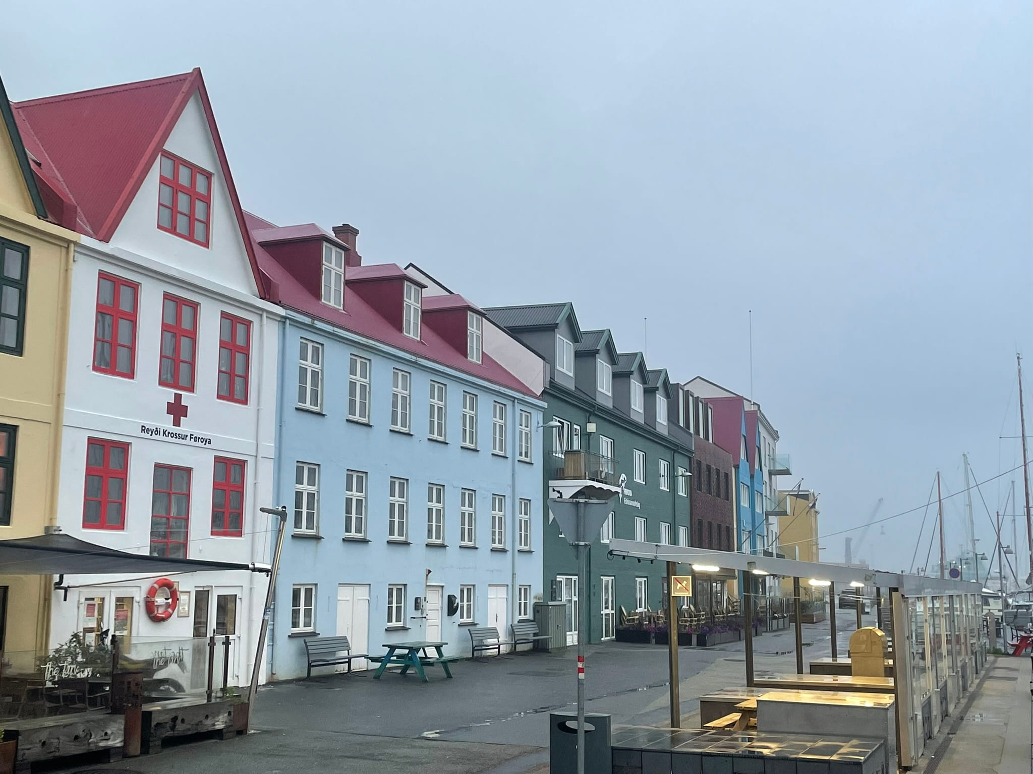 pastel colored buildings and a walkway along a harbor