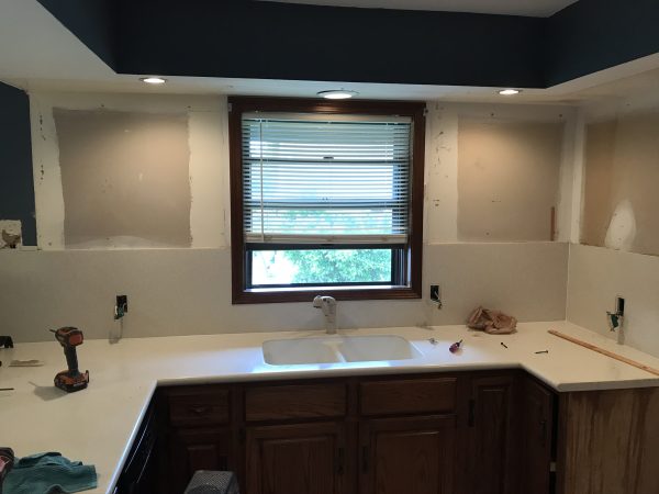 Outdated Box Kitchen Outdated kitchen with box ceiling and old countertops being demoed.