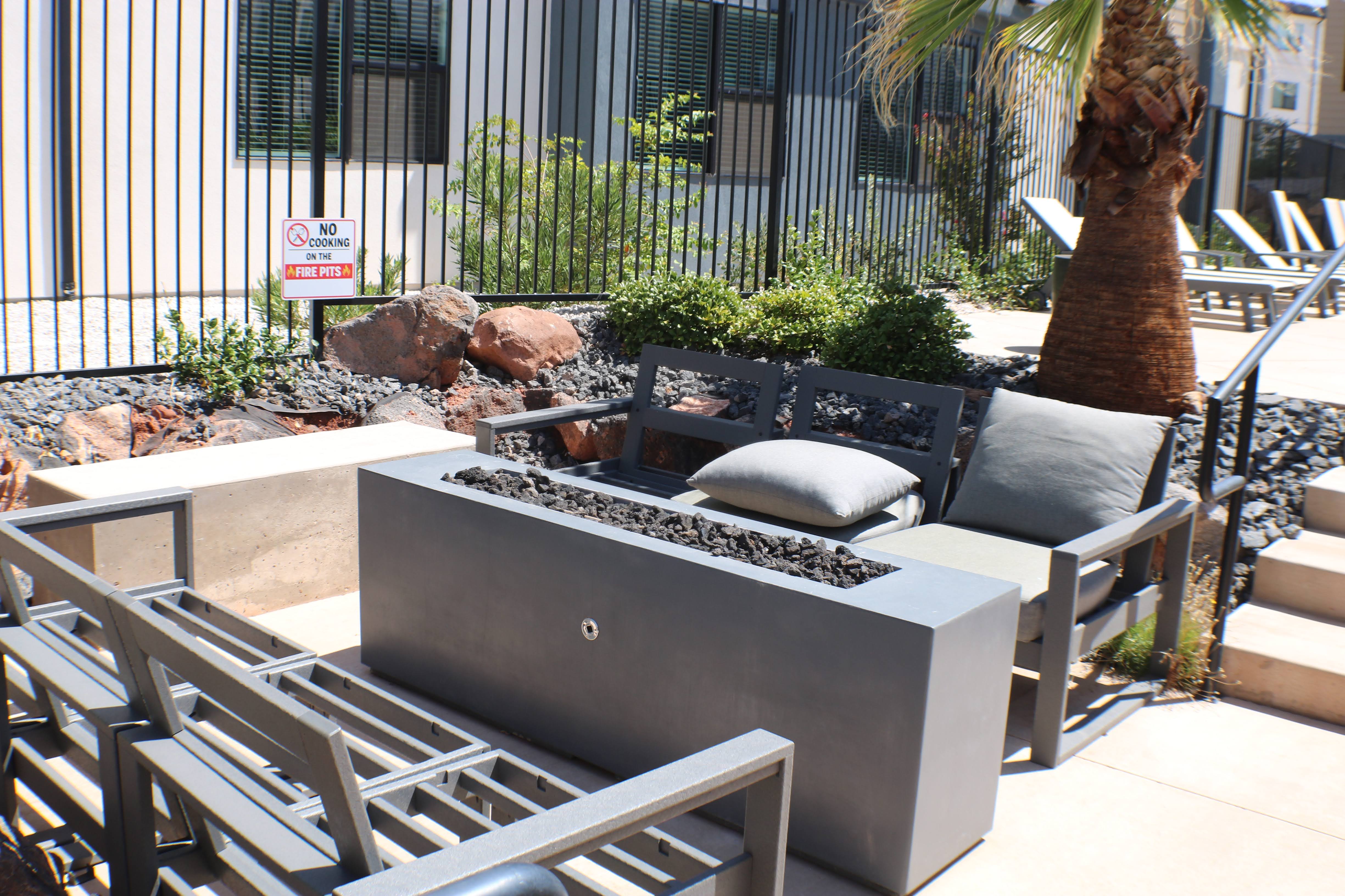 Outdoor gas firepit with surrounding lounge chairs
