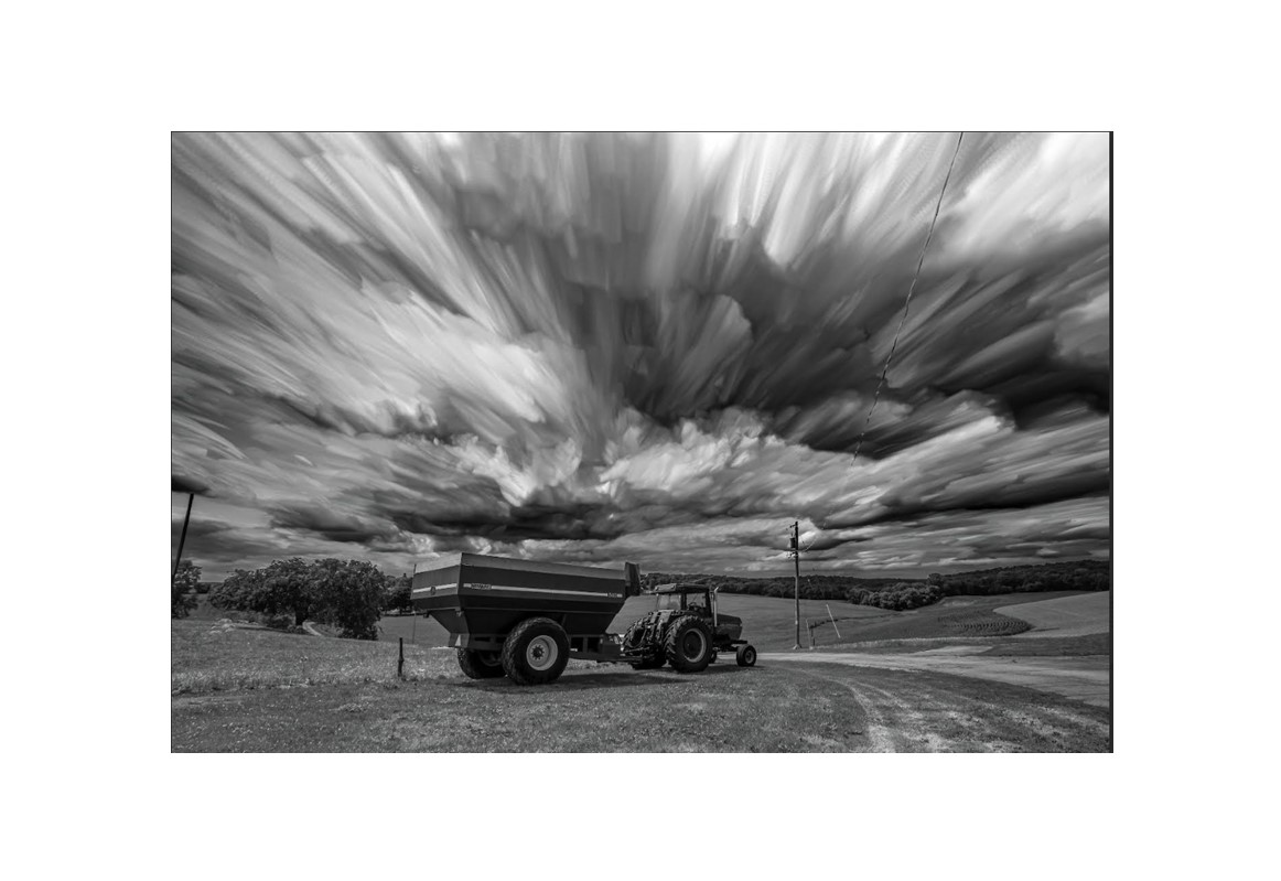 Tractor under timestacking clouds