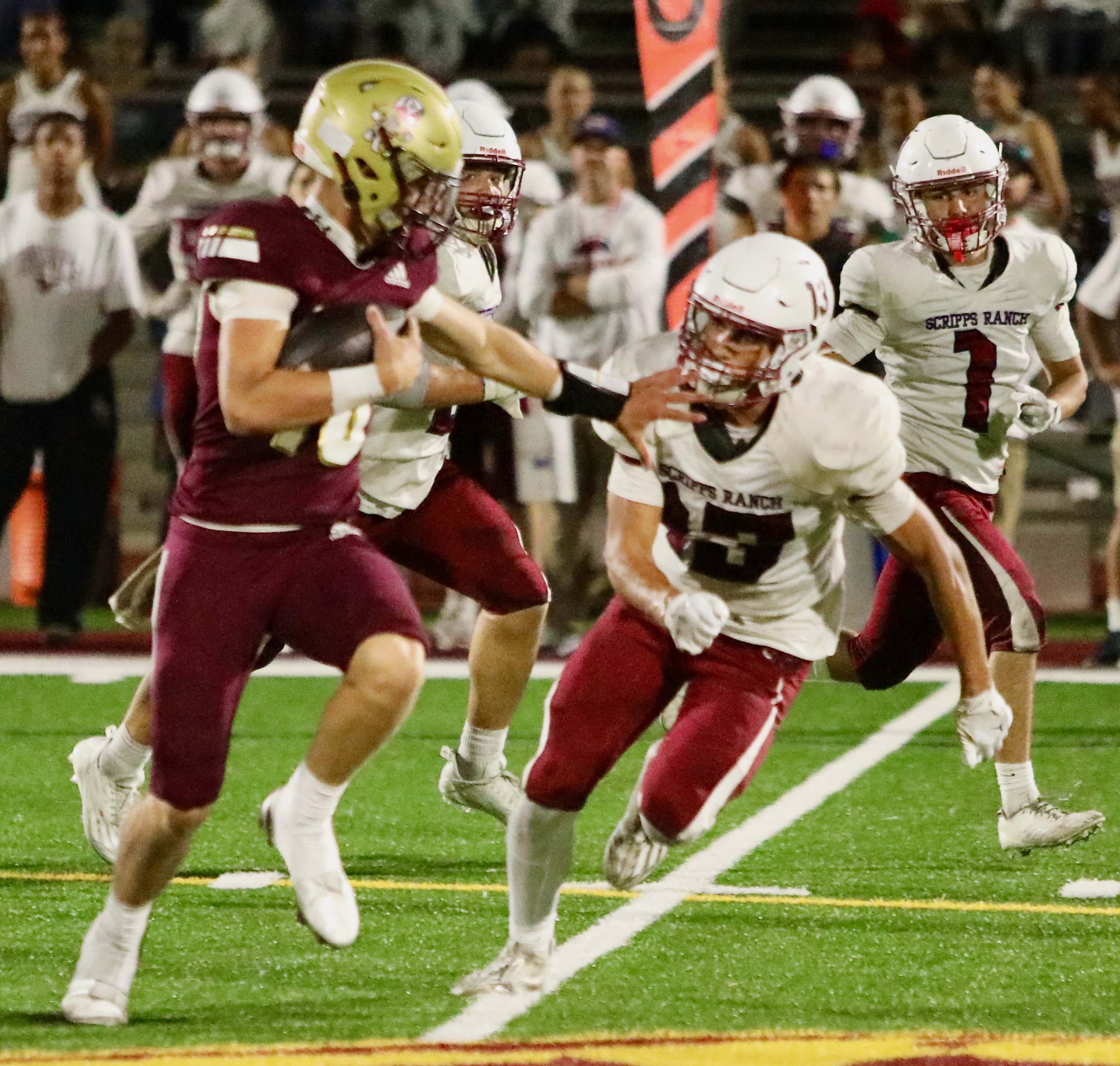 Pointer quarterback Henry Heuser stiff-arms a Scripps Ranch defender as he breaks away on a 56-yard touchdown run during a 25-3 win. (Photo by Scott Hopkins/Special to Peninsula Beacon)