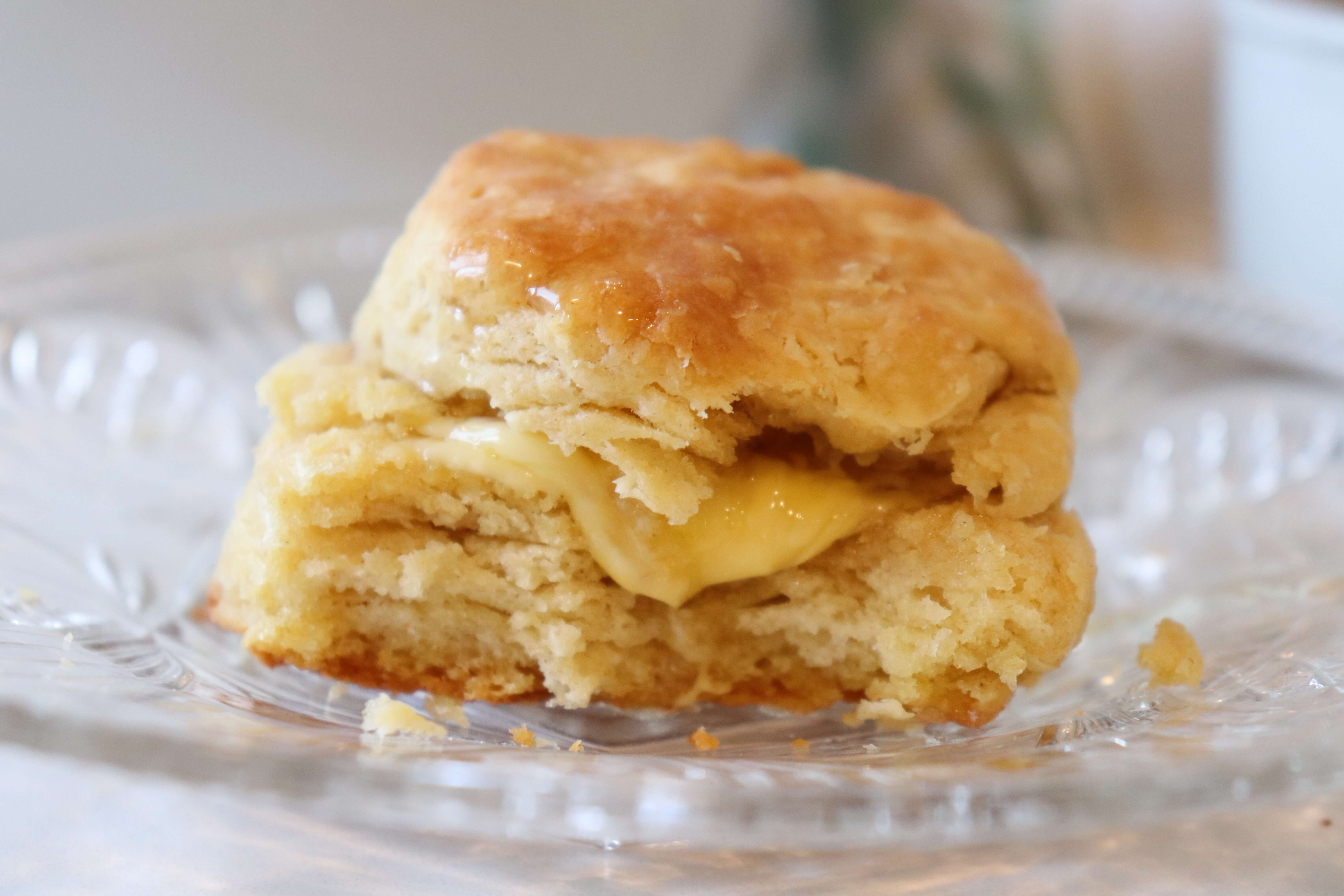 Buttermilk biscuit on a plate with butter and honey 