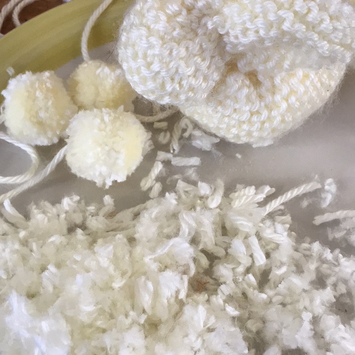 I love the mess that making poms, or bunny butts, creates.