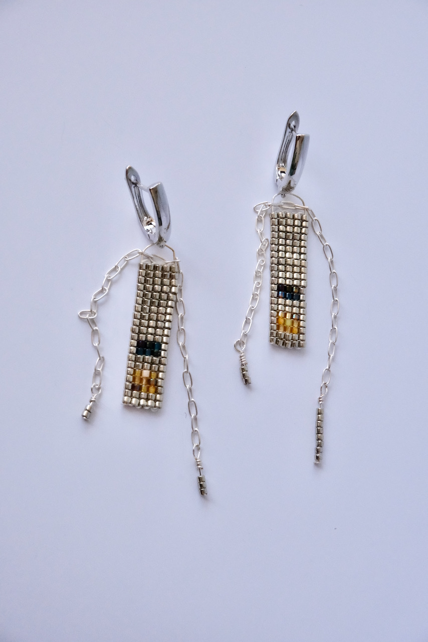 silver earrings with navy and amber coloured accents made of glass beads and silver chain