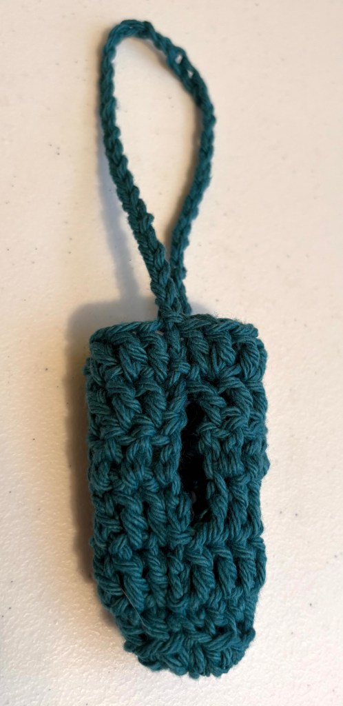 A crocheted poop bag holder