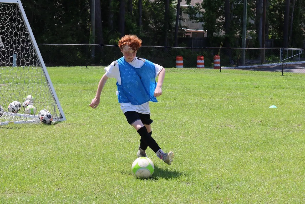 Youth player dribbling in our soccer camps.