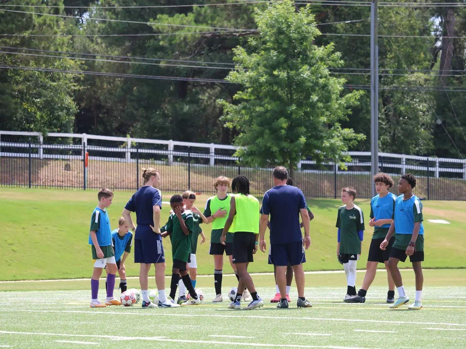 TM17pro Coaches explain the next drill in a soccer camp.