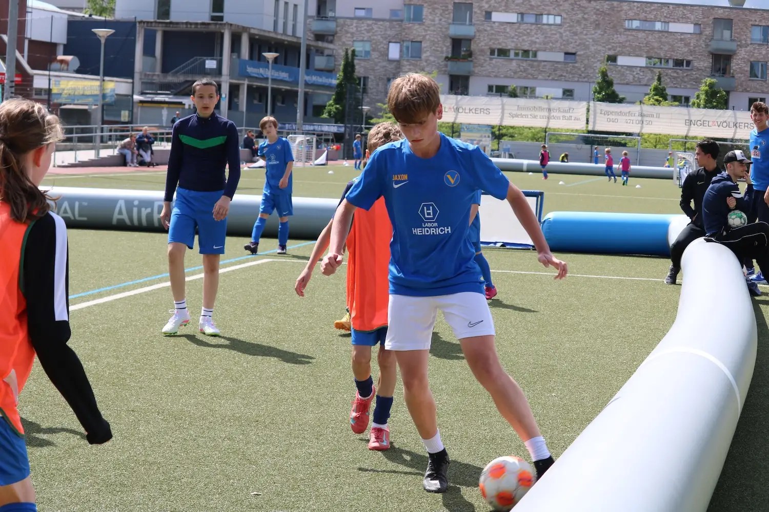 Youth soccer player is dribbling on a soccer pitch in the facility of RC Lens.