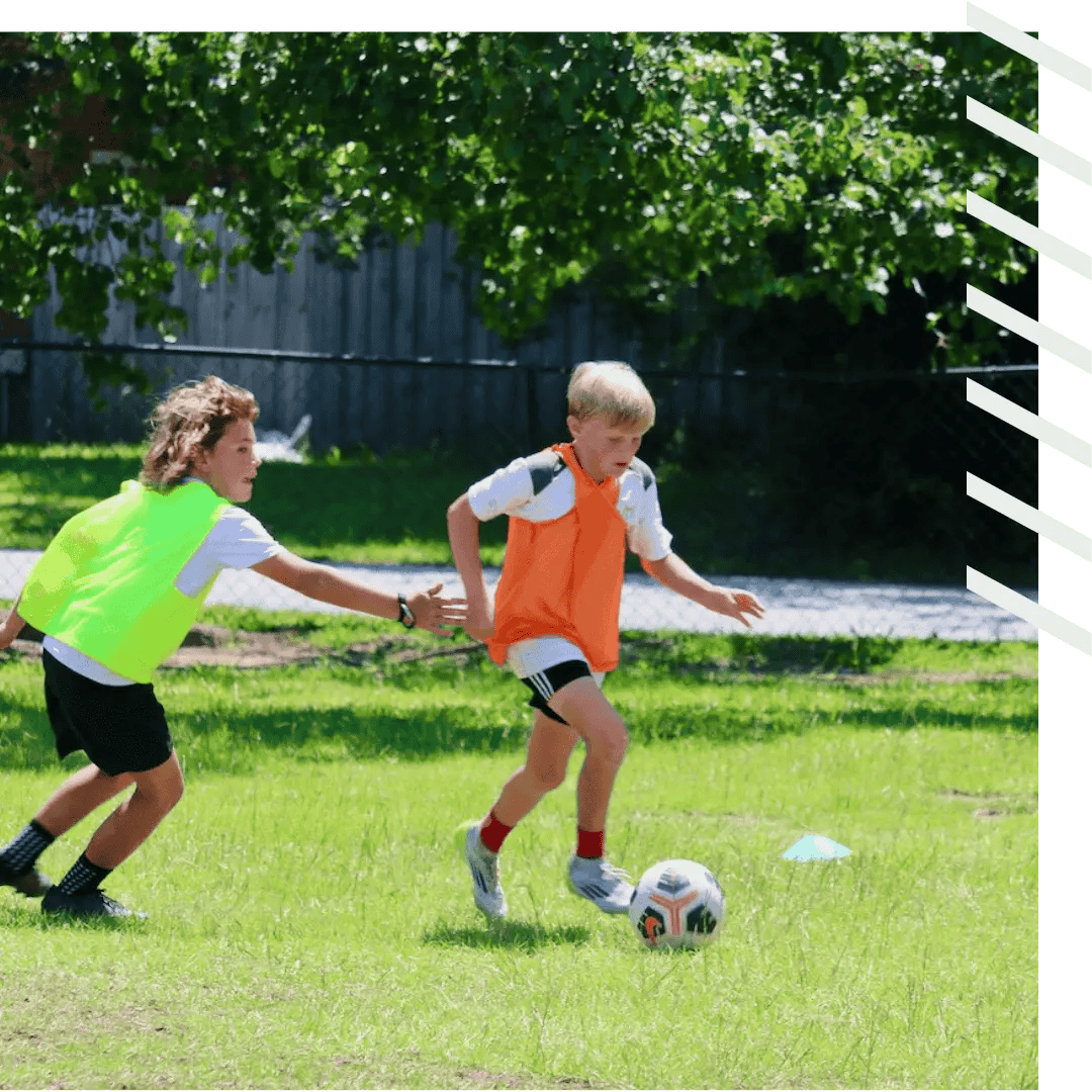 Two youth players compete in our soccer camp.