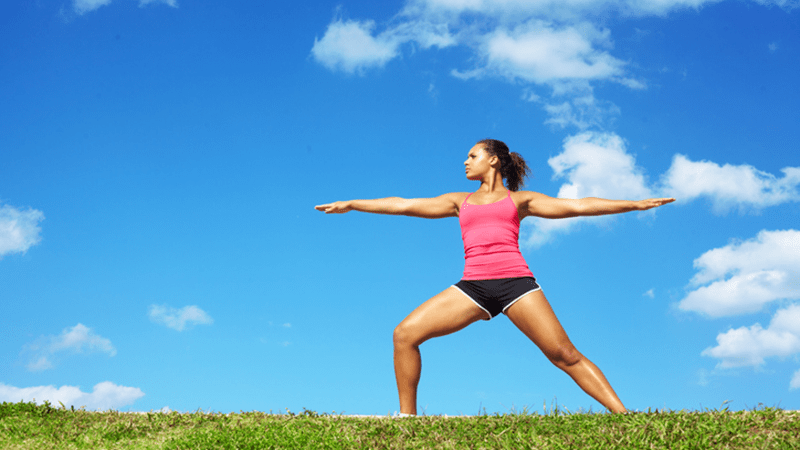 A person jogging outdoors in a sunny park, symbolizing spring training and fitness preparation for summer."