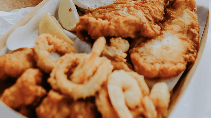 Fish fry flyer showcasing Tiara’s Kitchen menu with catfish, wings, and pricing details for a community fundraiser.