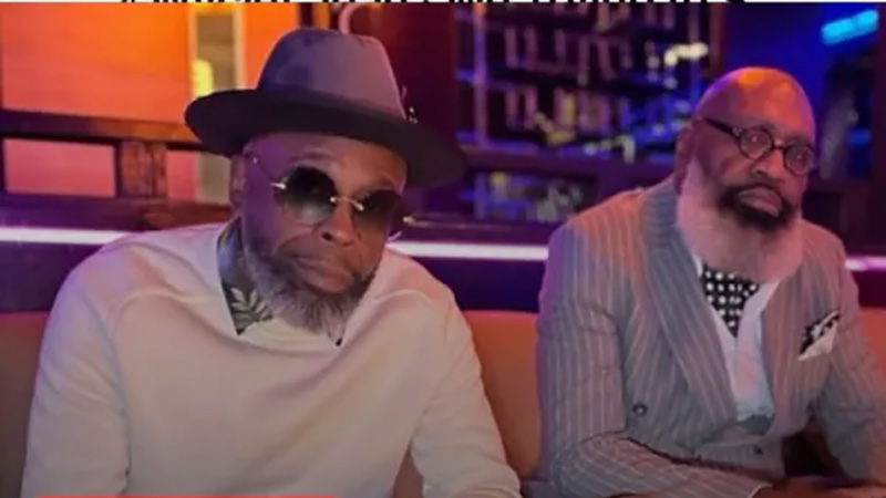 Two distinguished Black leaders in a lounge setting, symbolizing mentorship and innovation in AI education.