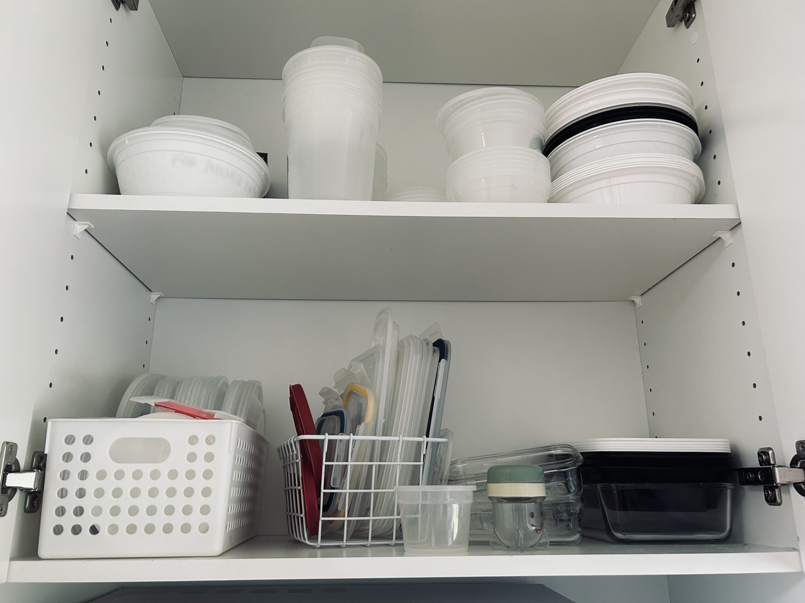 Kitchen Cupboard with plastic containers, before reorganization