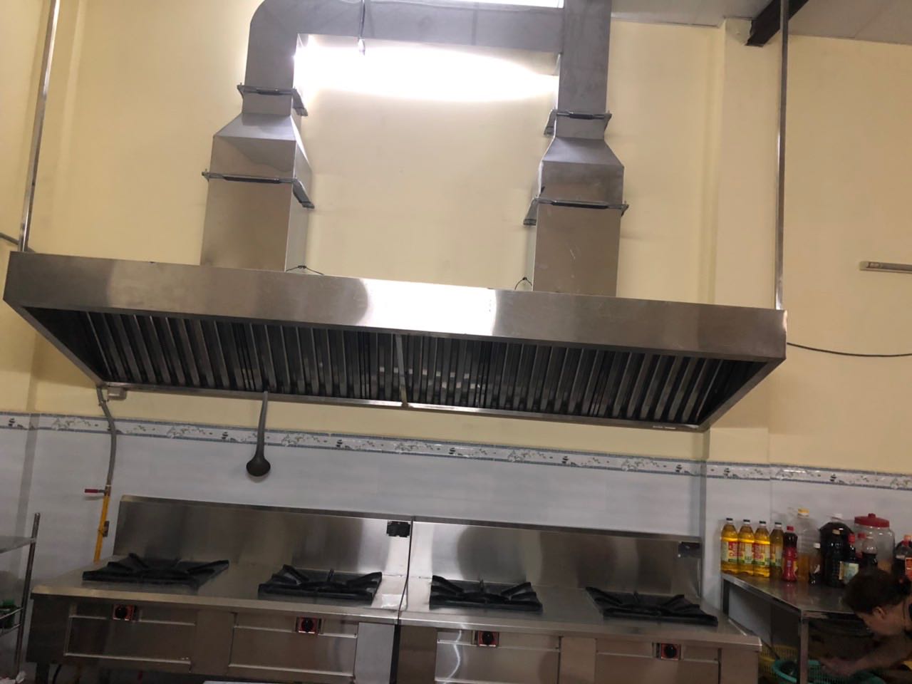The center’s new kitchen stove and ventilation hood stand against a tiled wall.