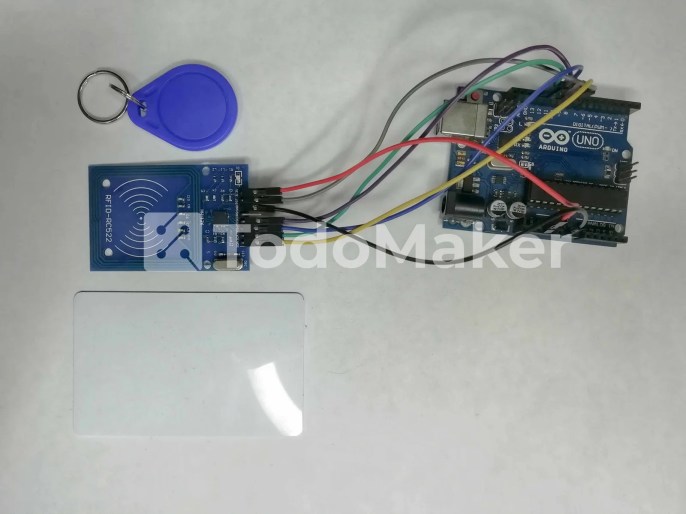 Arduino UNO conectado a un MFRC522 junto a dos etiquetas RFID pasivas.