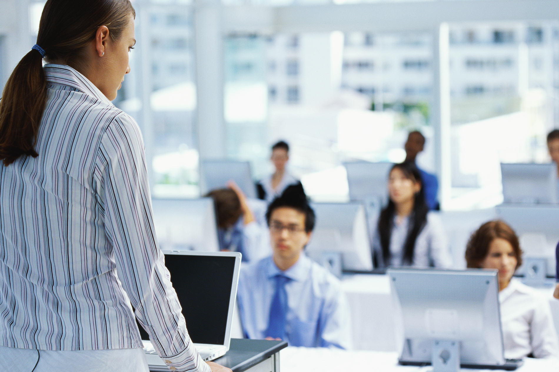 businesswoman training a group of business executives