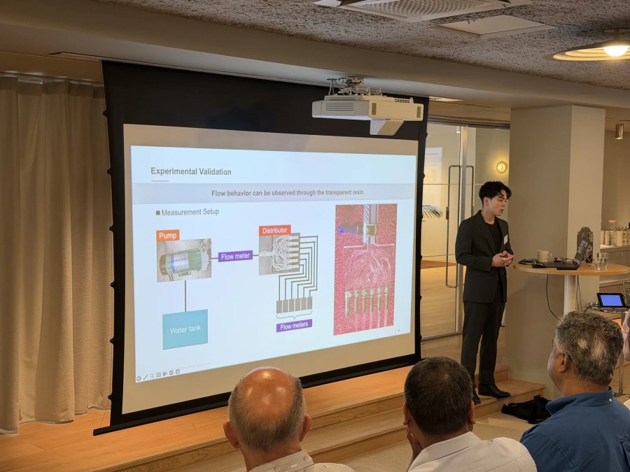 Soma Takeuchi of SCSK presenting Ricoh and SOLIZE case studies on topology-optimized heatsinks