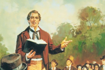 Painting of Joseph Smith preaching outdoors to a gathering of Mormons with an open Bible in one hand.