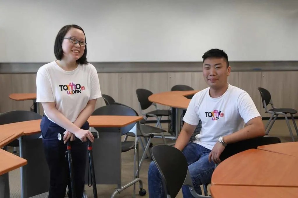 Temasek Polytechnic students Alina Seow (left), who has cerebral palsy, and Rayner Teo, who has a condition called Leber's hereditary optic neuropathy that affects his vision