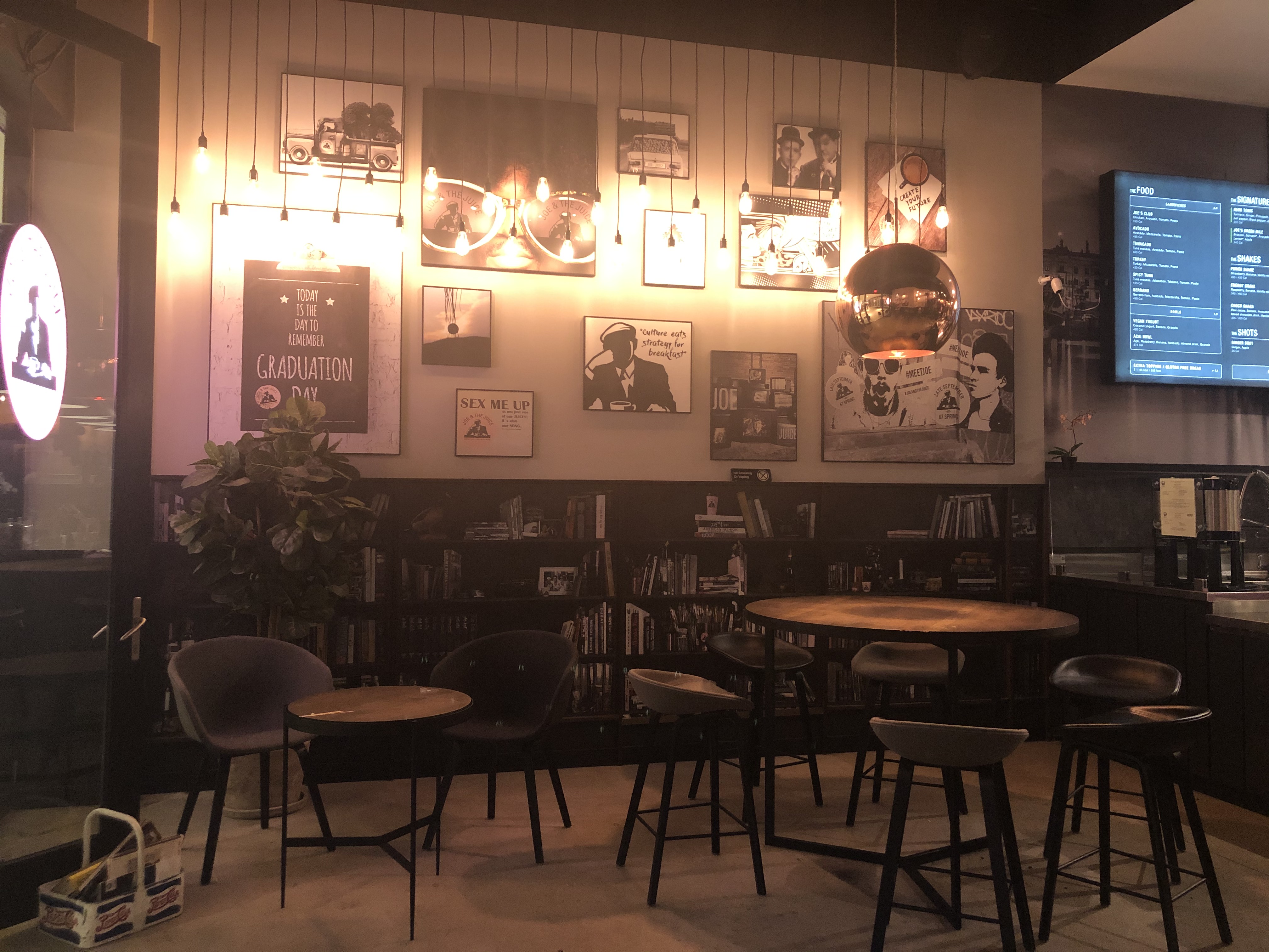 Image inside of Joe and the Juice coffee shop which has dim lighting and chill ambience