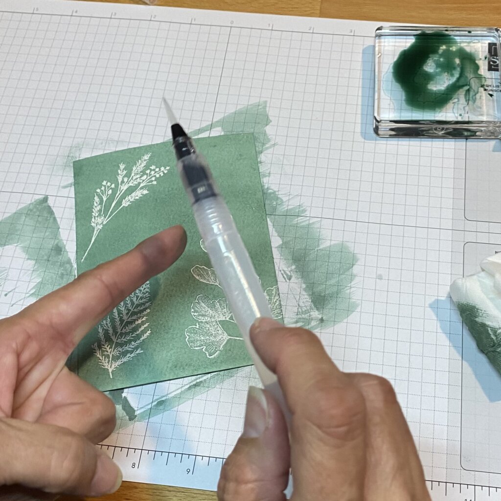 Flick water painter to add drops of water to inked paper