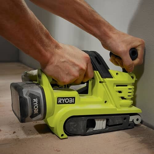 sanding a floor belt sander on a wooden floor