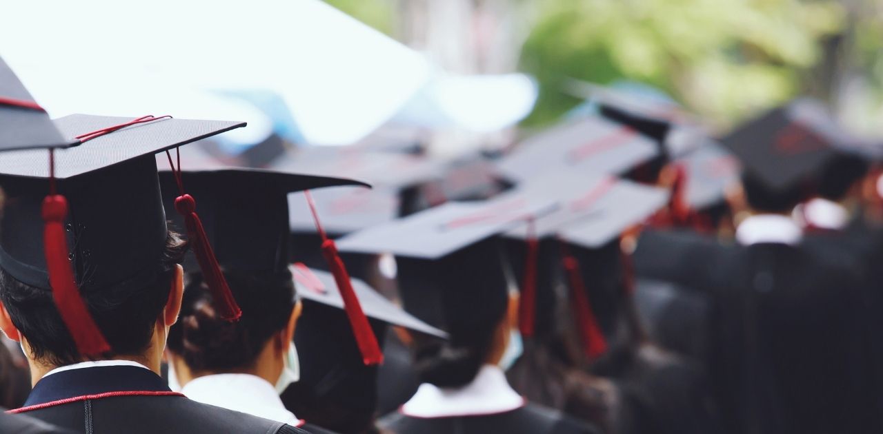 graduation hats with red ribbon