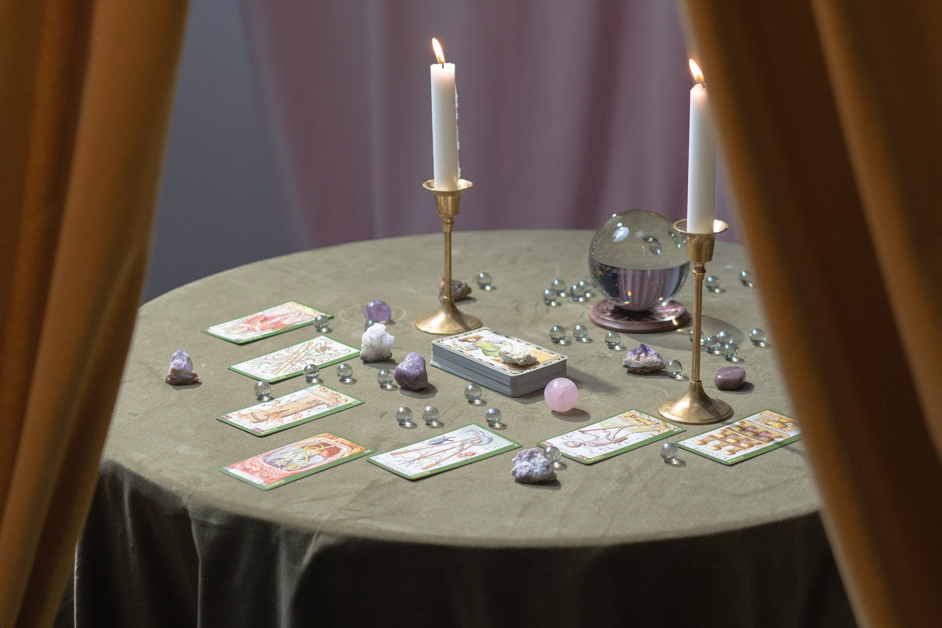 tarot cards and a crystal ball on the table
