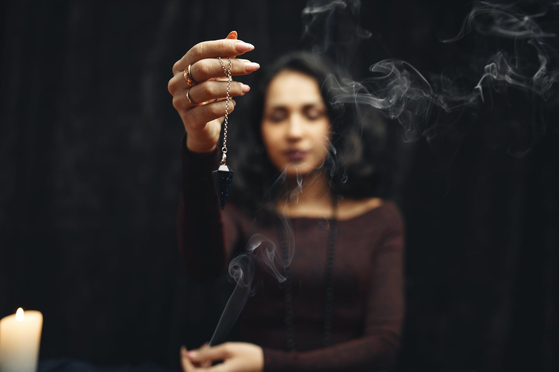 woman meditating with pendulum