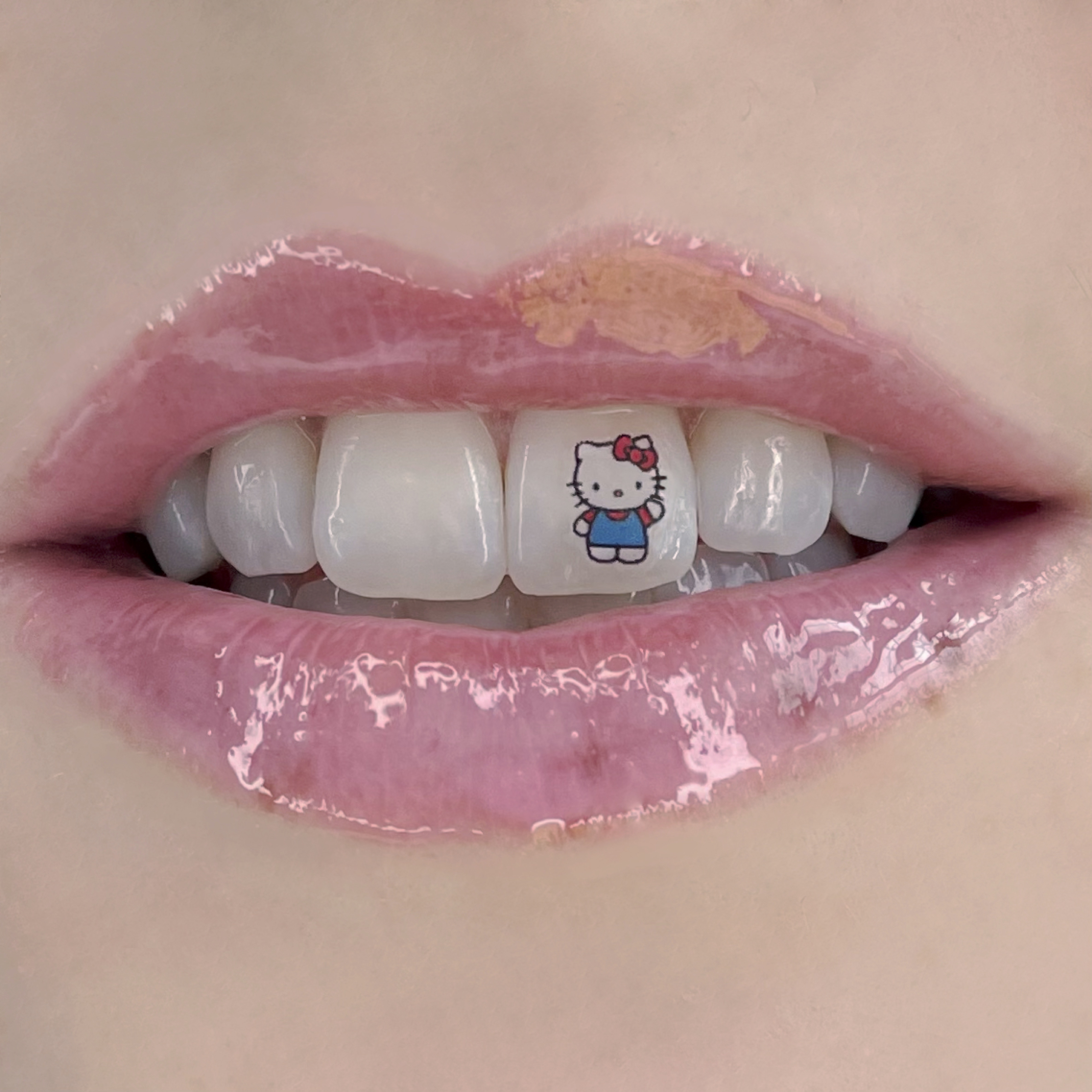 hello kitty tooth tattoo