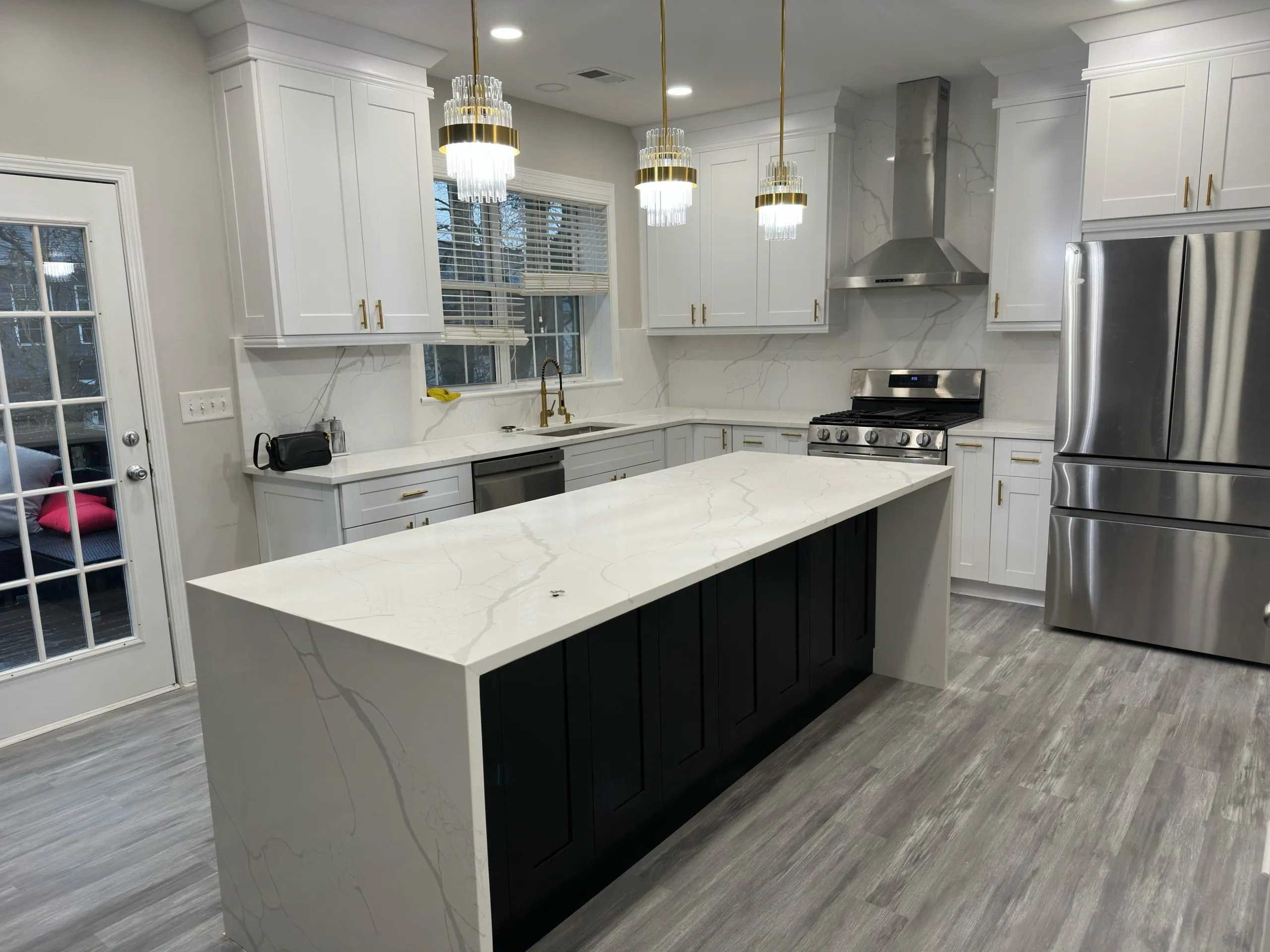 White Shaker kitchen with Calacatta quartz Espresso island