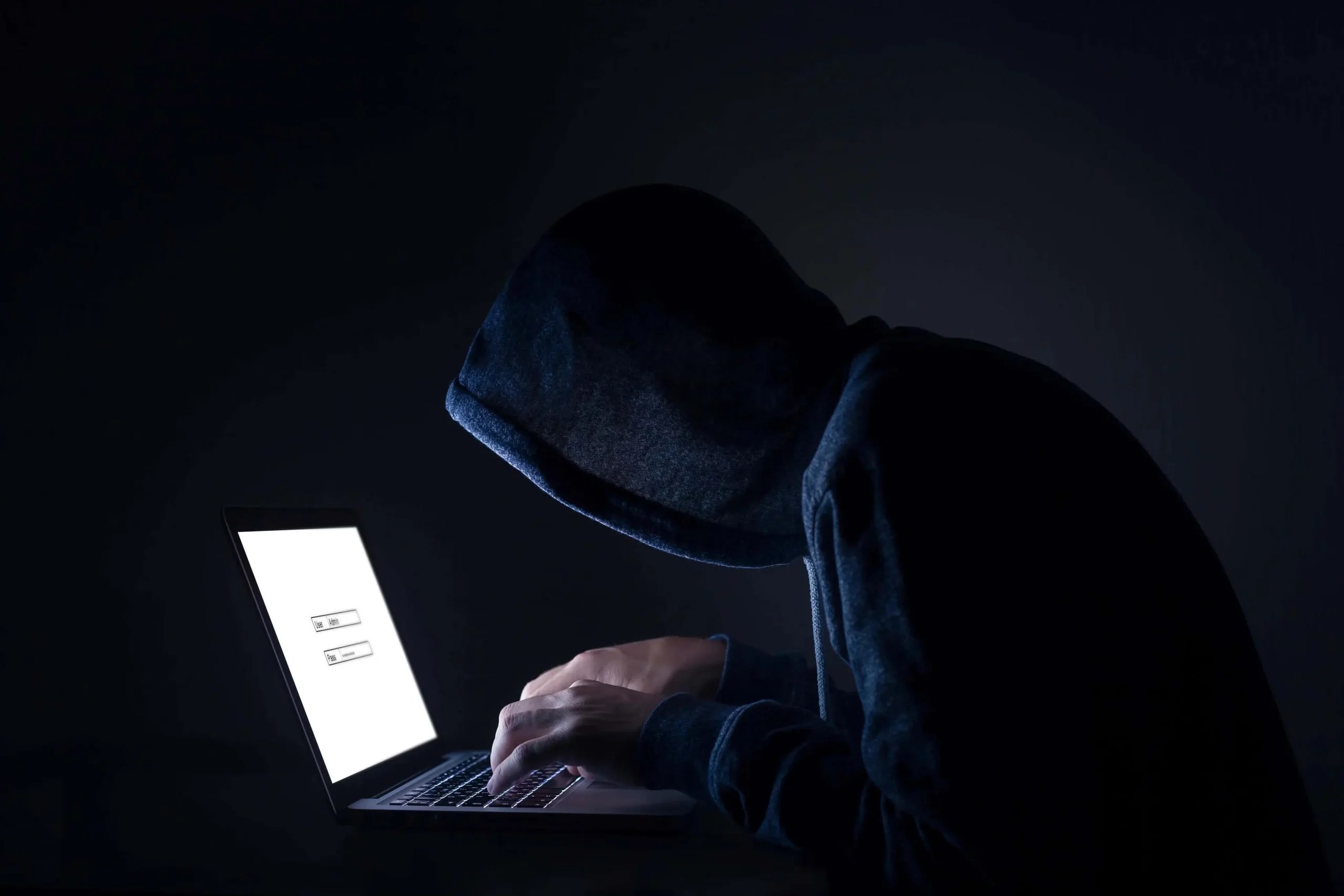 Attacker with a laptop planning a cyber attack