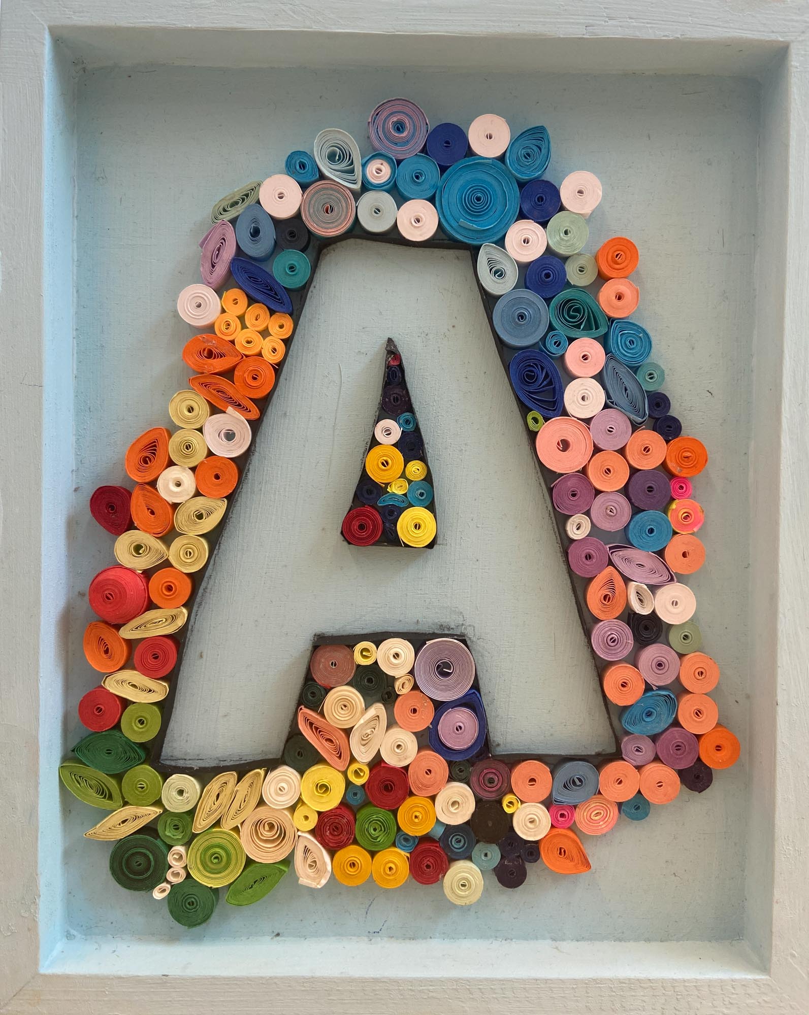 The letter A made from quill art.