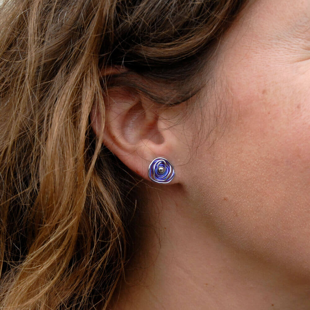 Beautiful purple, hypoallergenic titanium earring on woman's ear.