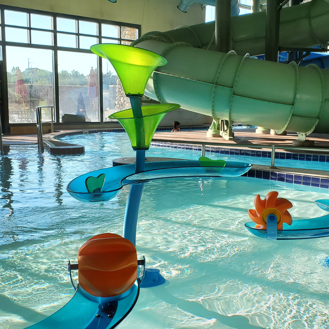 Gyms with Swimming Pools | a spinning water feature in the zero-depth section of the trails rec center's activity pool.