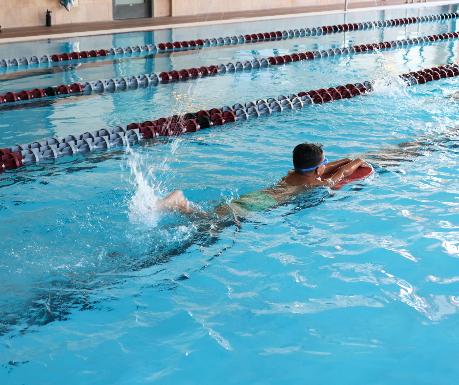 Child swimming with a kickboard