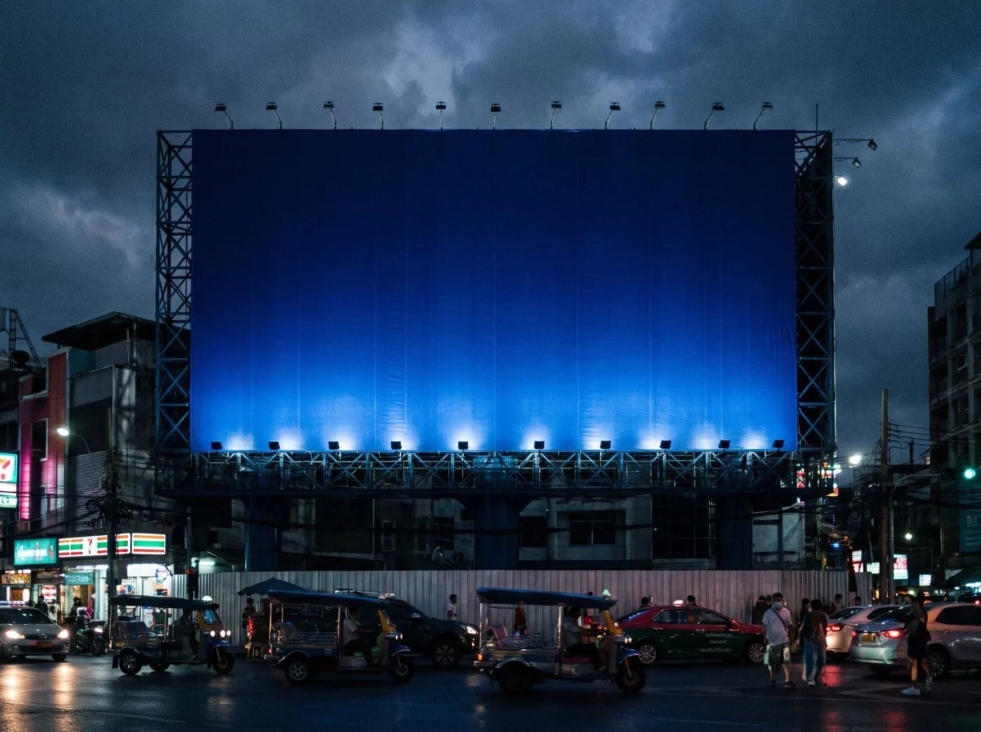 Brand billboard lit against a dusk sky