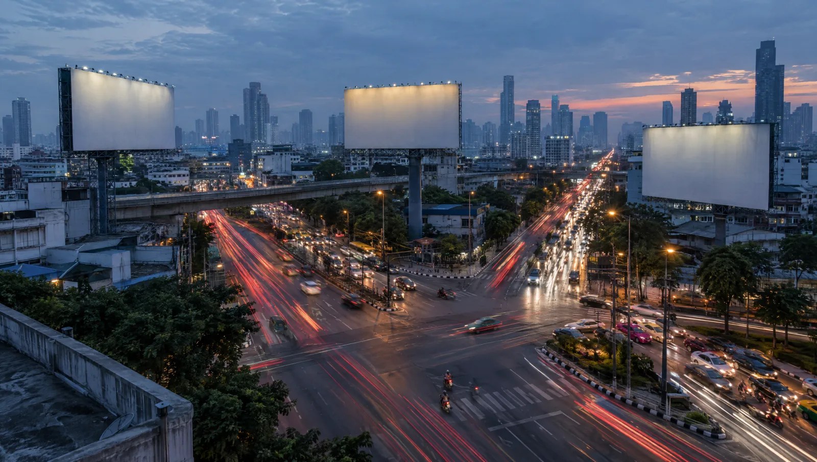 Busy Bangkok intersection at dusk seen from above with billboard structures
