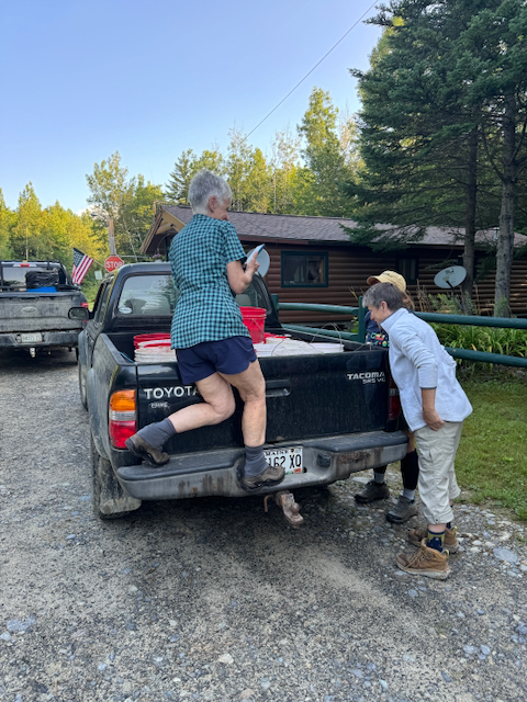 Ladies looking into the truck at the bear bait.