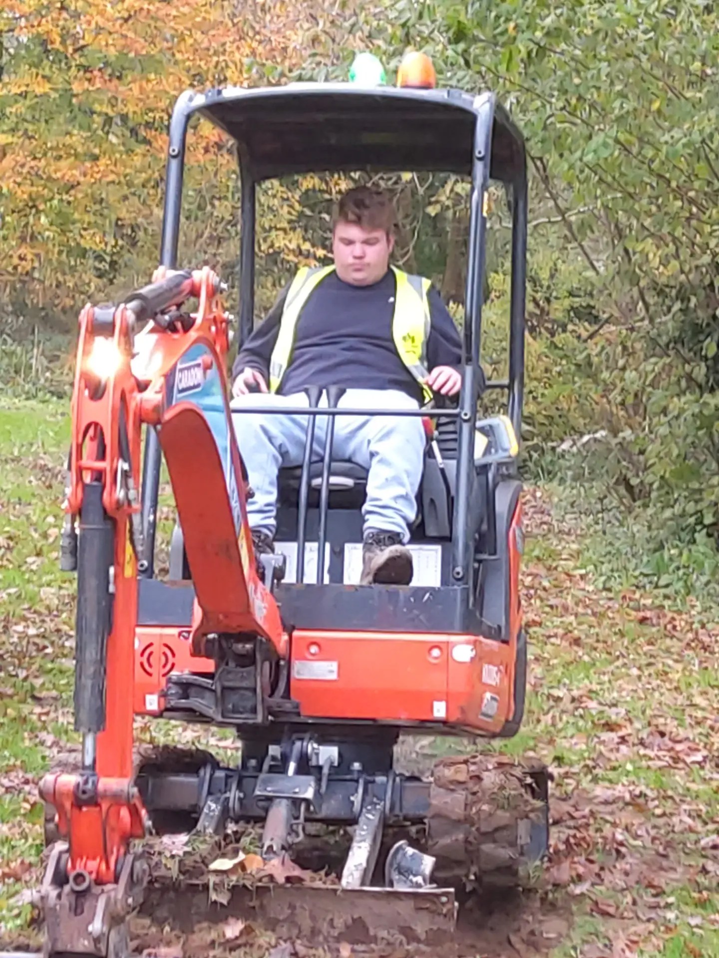 Student operating digger