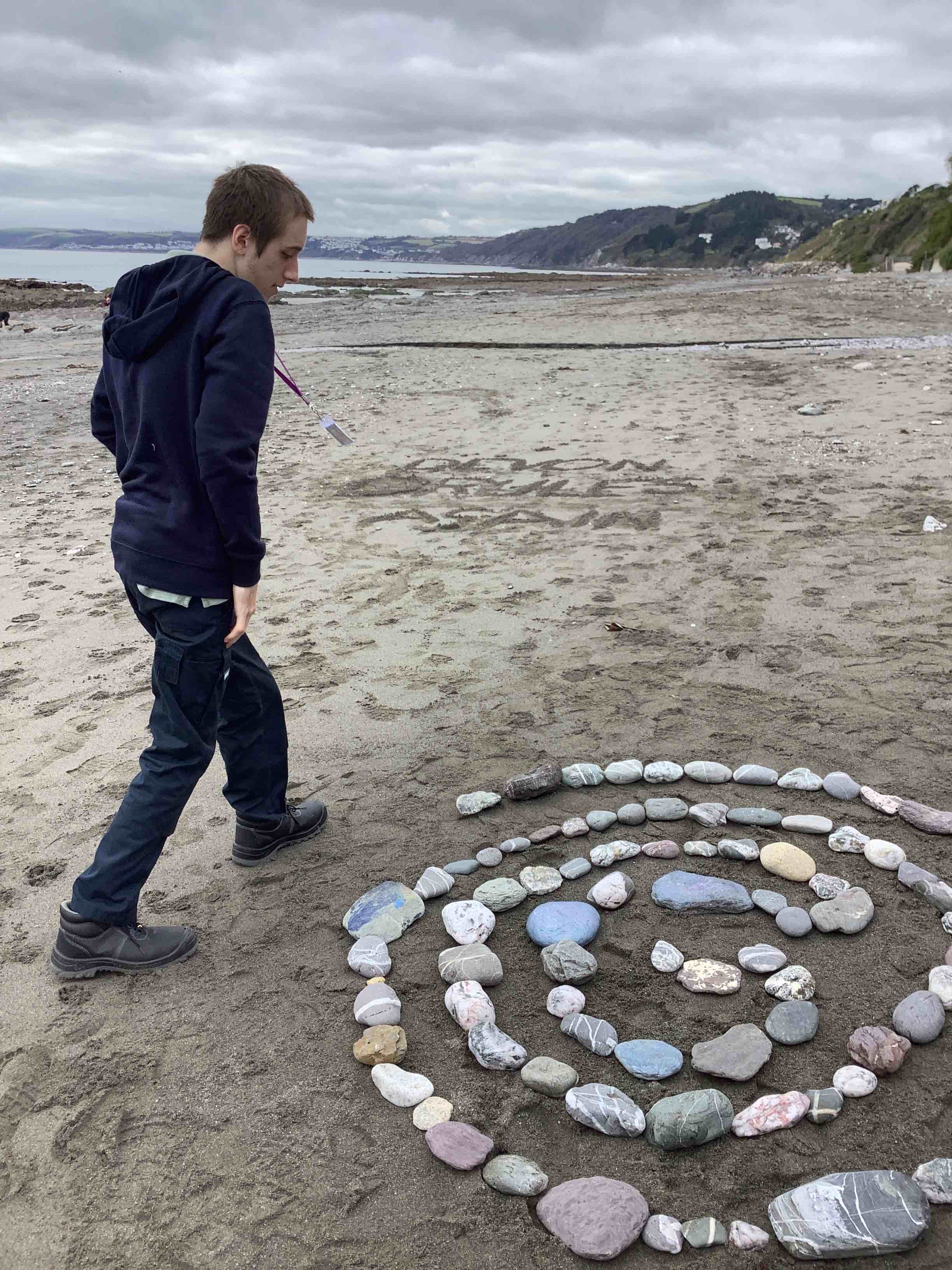A young man has made spiral beach art
