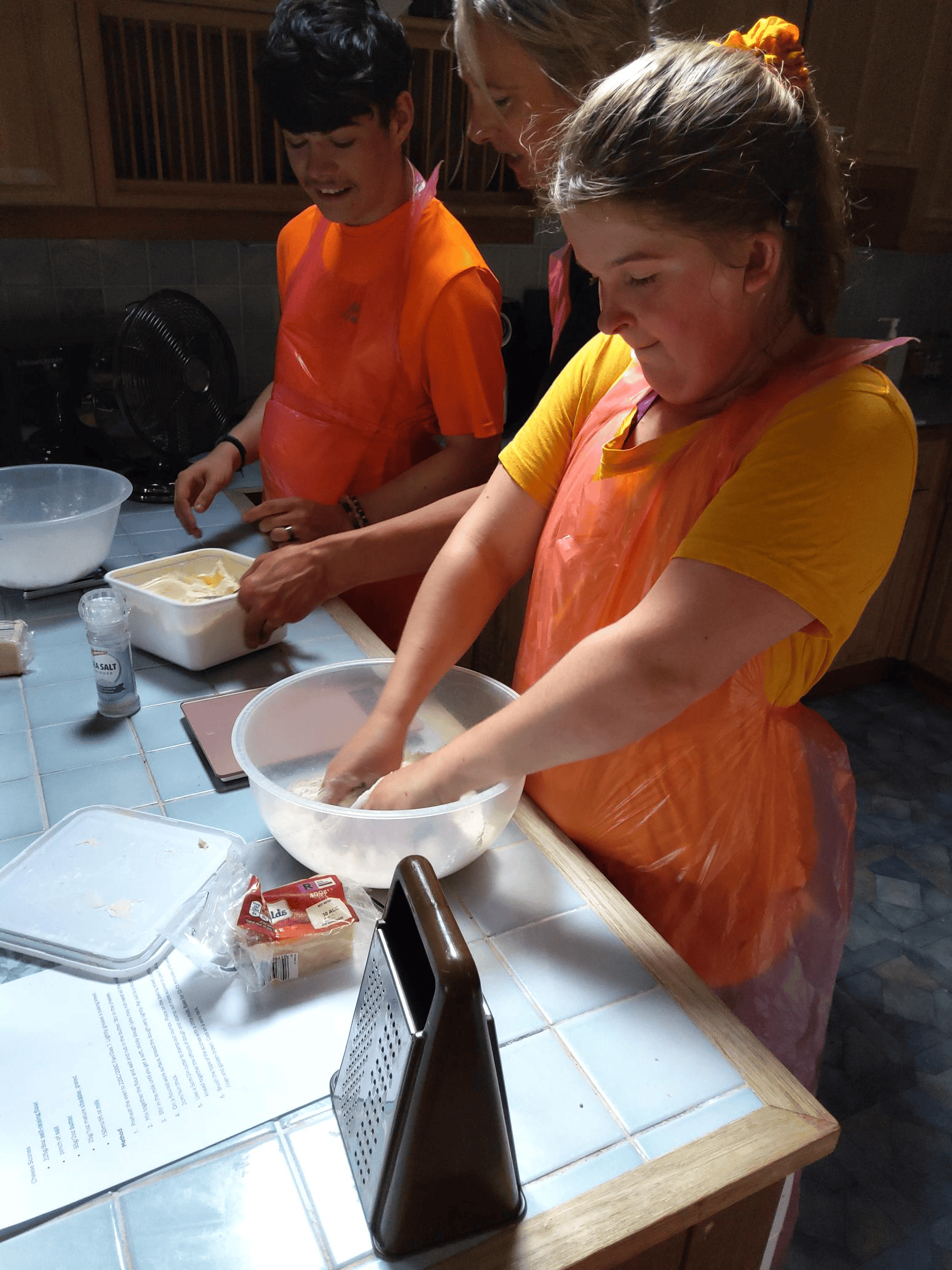 two students baking, learning life skills, budgeting, cooking and shopping